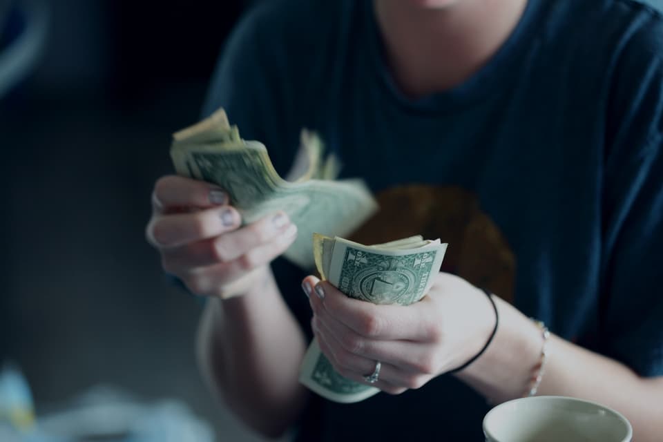Hands holding and counting cash bills