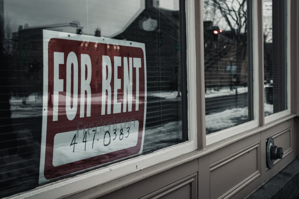 For rent sign in a house window
